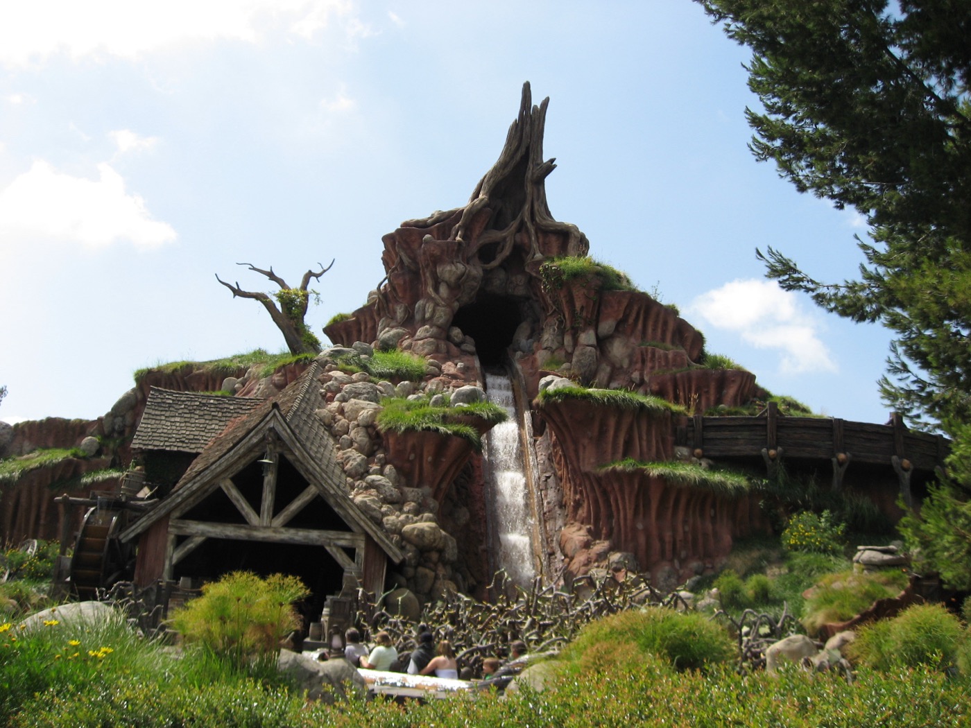 A log flume ride: a walled channel climbing to a crest, then the drop